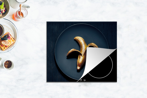 Herdabdeckplatte Goldene Banane auf einem dunklen Hintergrund-4