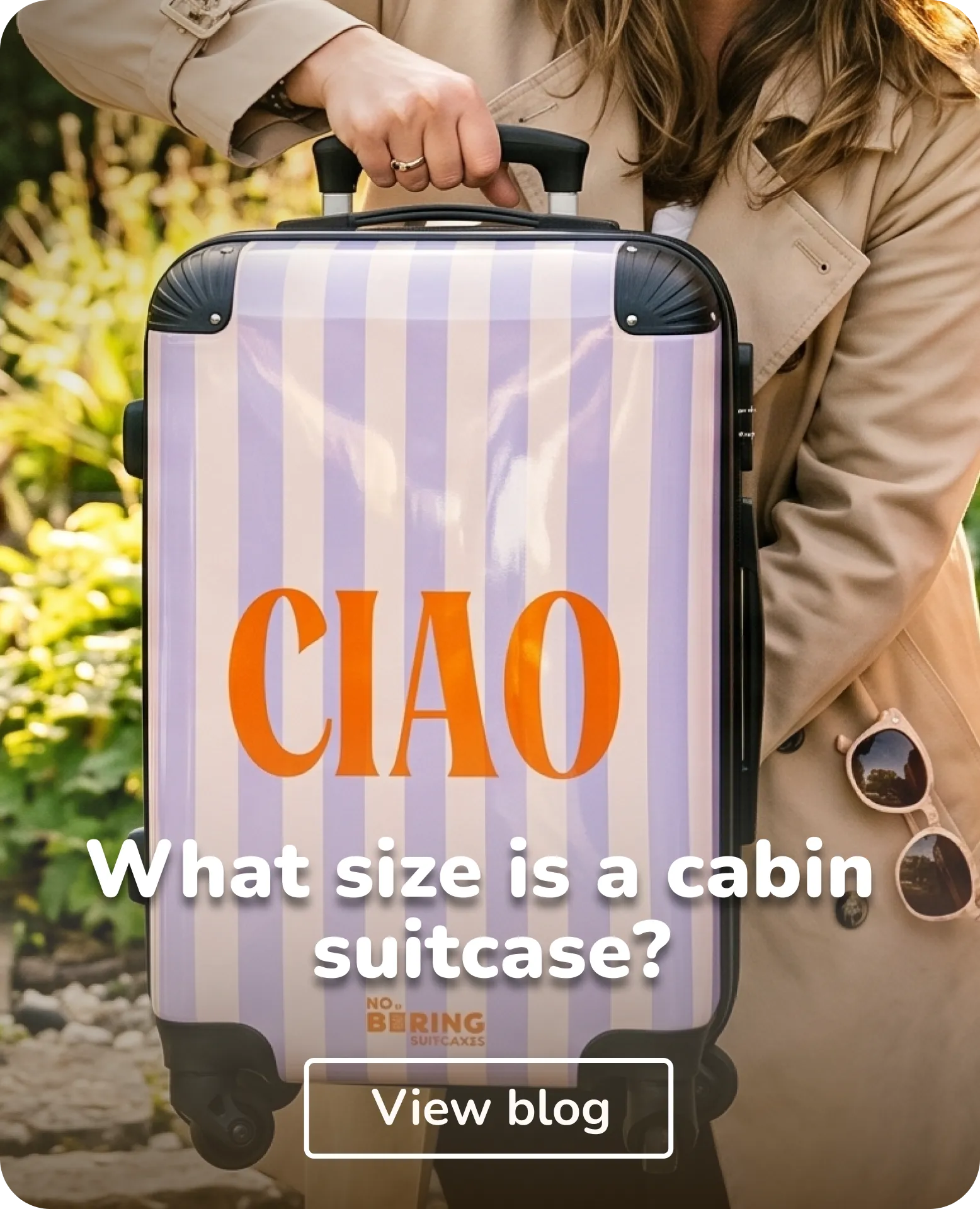 woman holding cabin size suitcase