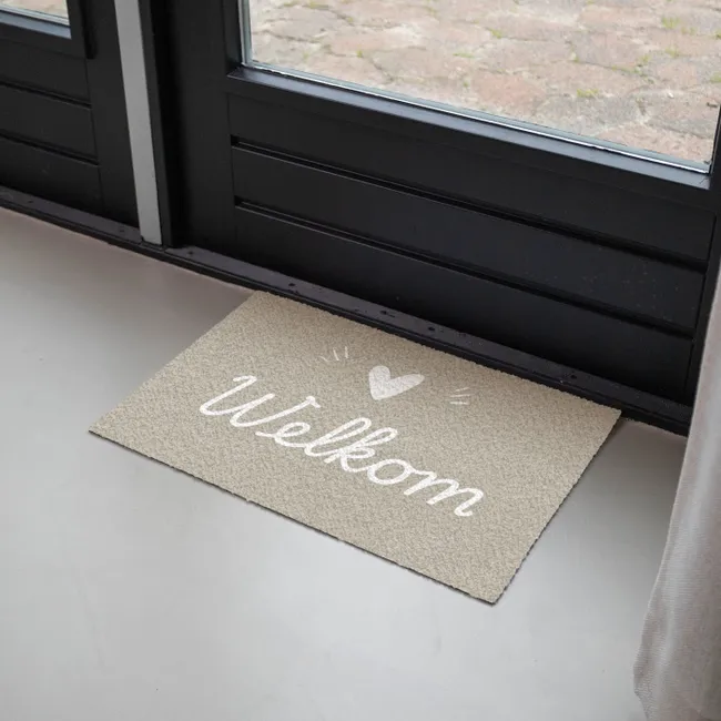 Foto van een deurmat met welkom